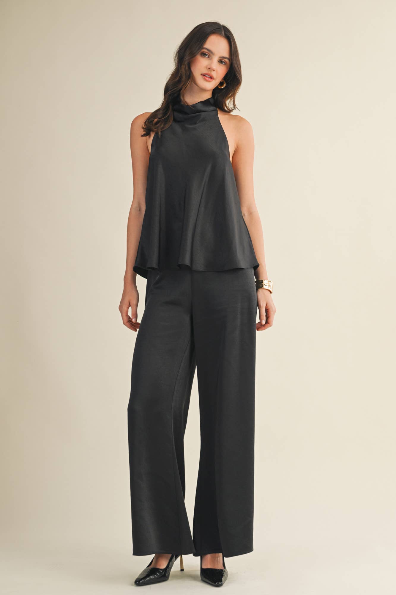 Chic women’s satin trousers with wide legs and sleek zipper detail.