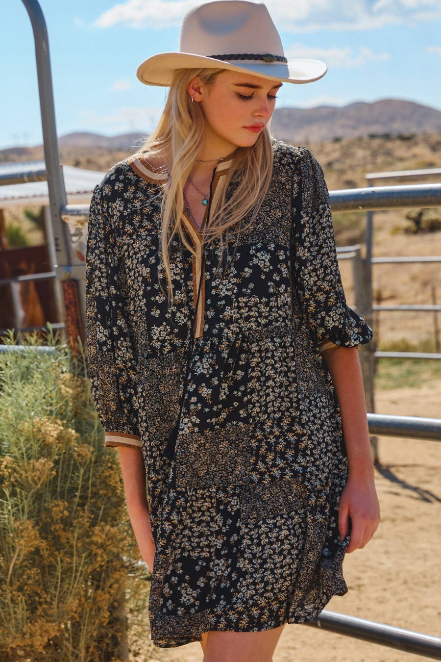 Flowy tiered dress with 3/4 sleeves and small floral print.