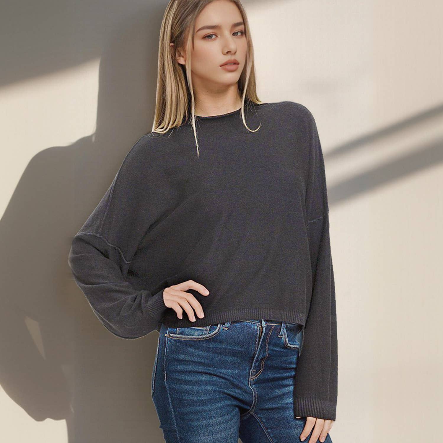 Women’s black oversized sweater with relaxed fit and ribbed hem.