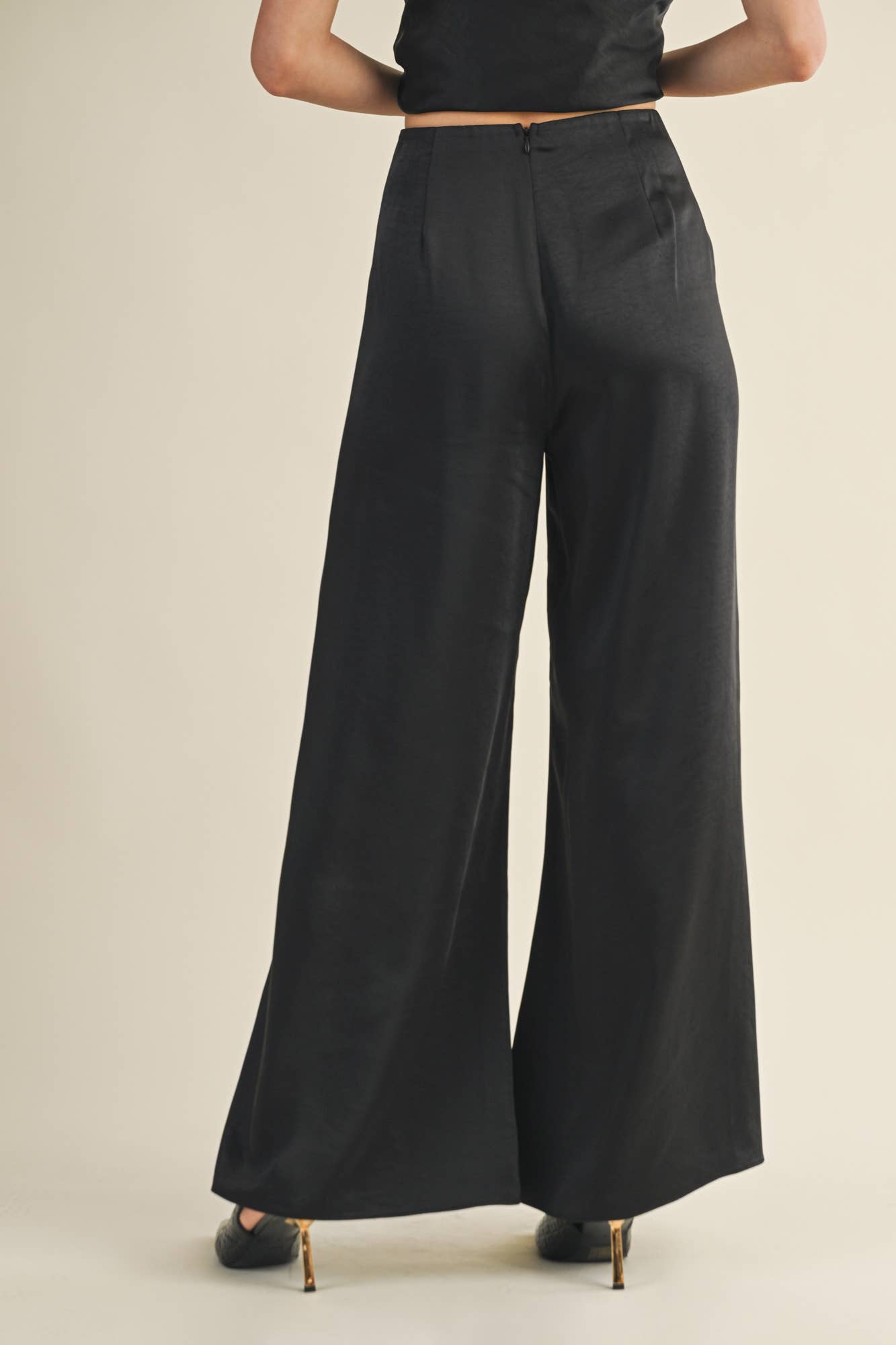 Black satin wide-leg pants styled with back zip for tailored fit.