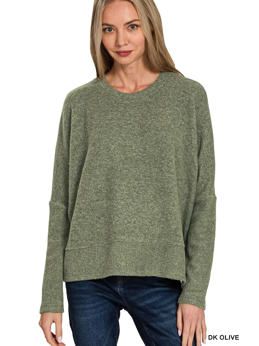Women’s relaxed fit pullover sweater styled with denim jeans.