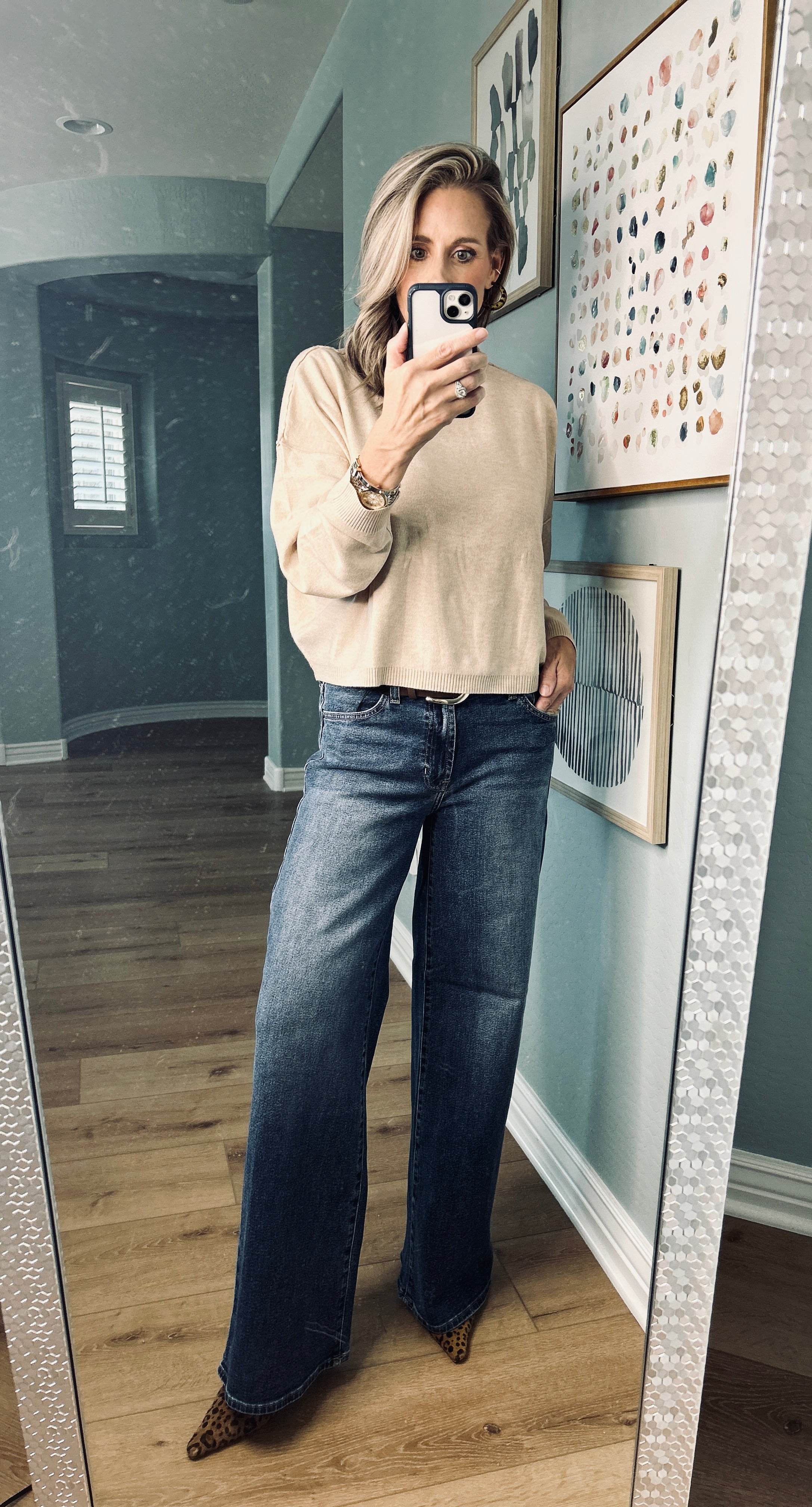 Neutral beige knit pullover styled with casual denim jeans.