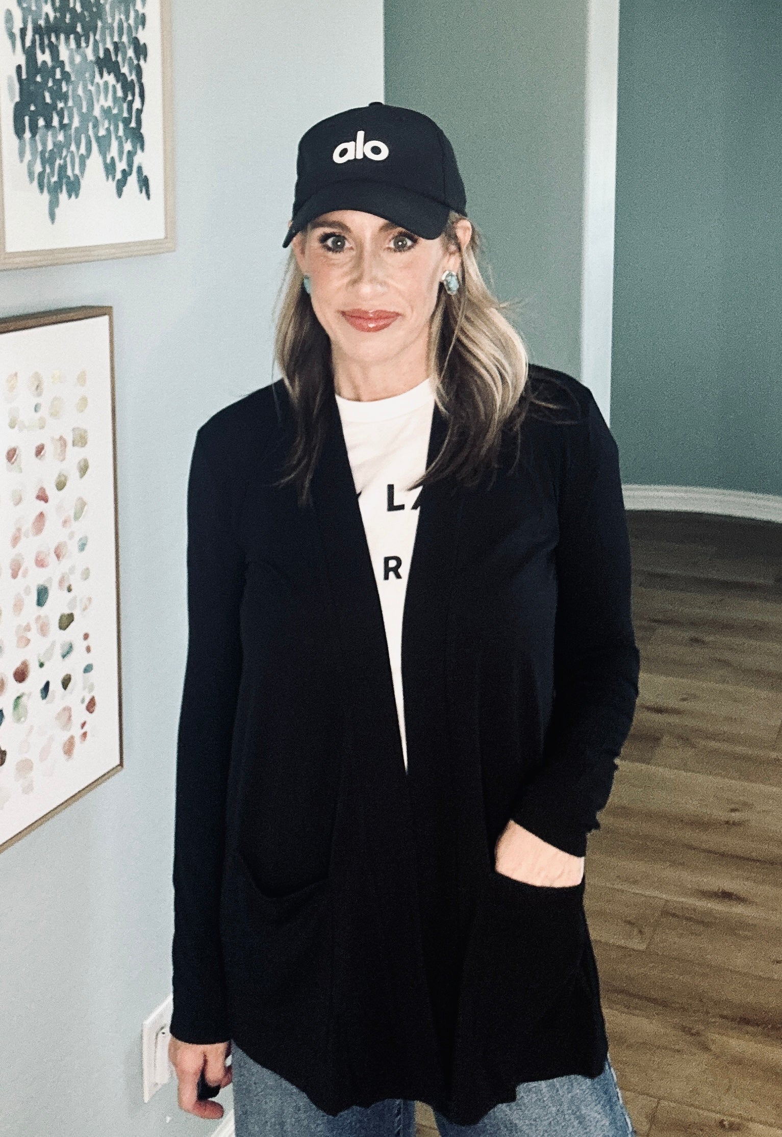 Women’s black open-front cardigan with long sleeves and patch pockets.