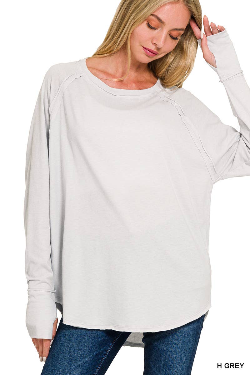Classic white women’s long sleeve pullover top styled with denim.
