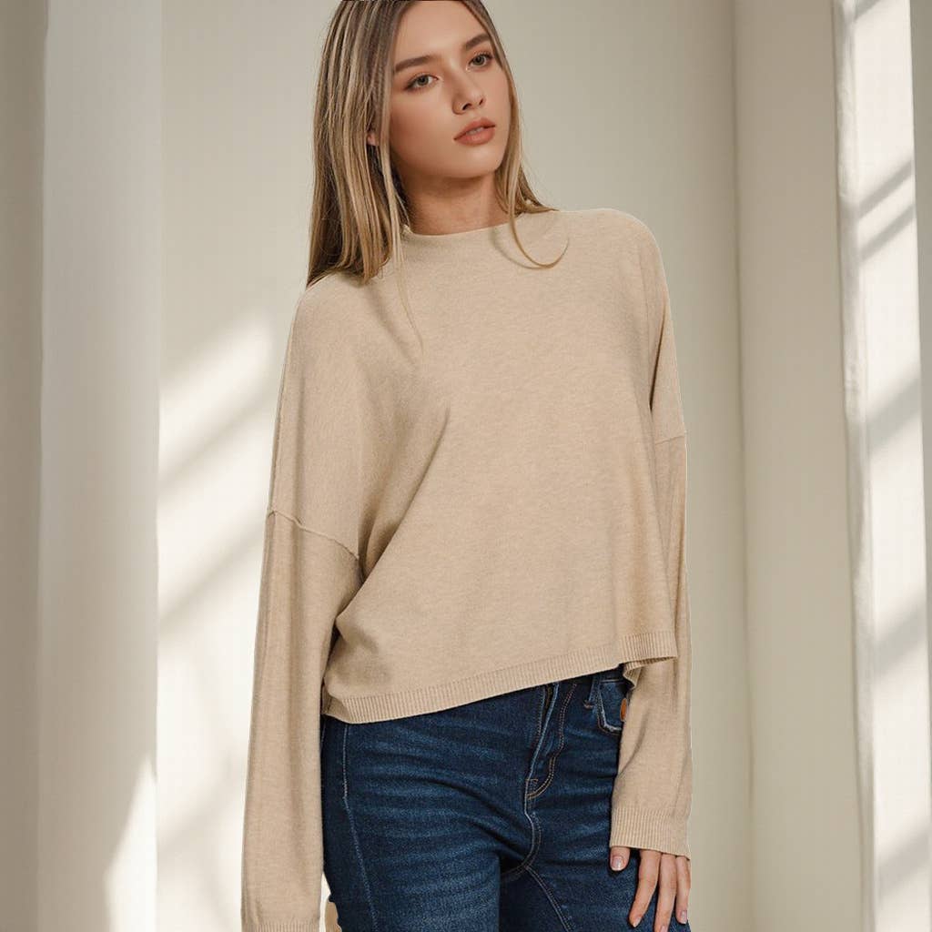 Women’s beige oversized sweater with relaxed fit and ribbed hem.