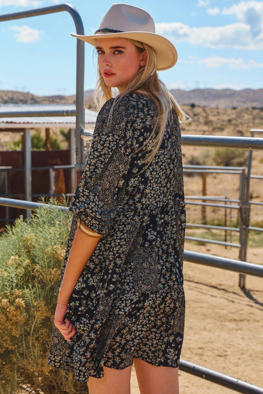 Women’s relaxed fit floral dress with tan trim and tassel ties.
